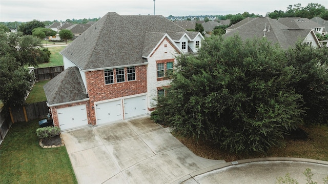 view of front of home with a garage and a front lawn