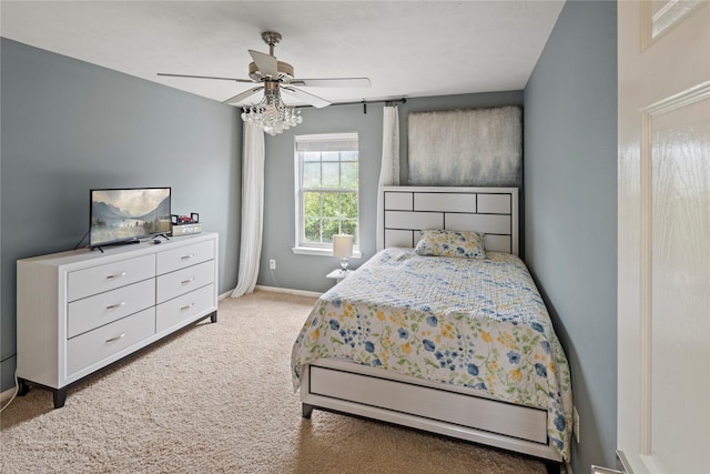 bedroom with light carpet and ceiling fan