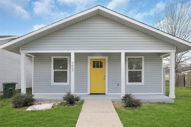 bungalow-style house with a front lawn and a porch