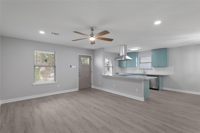 kitchen with dishwasher, backsplash, island exhaust hood, kitchen peninsula, and light hardwood / wood-style flooring