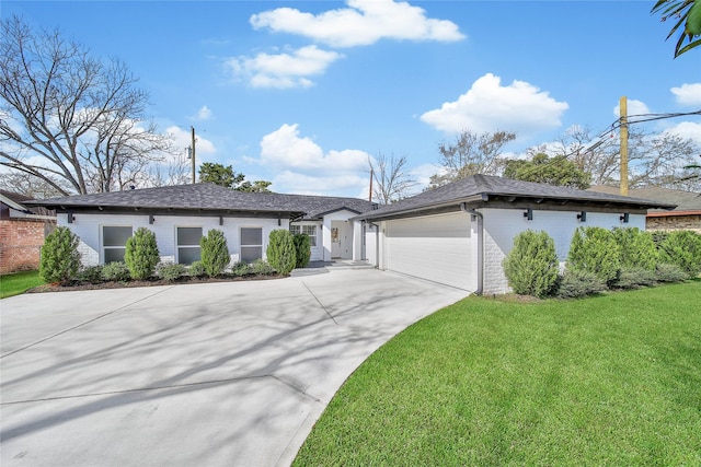 view of front of home with an attached garage, driveway, a front yard, and brick siding