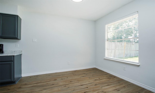 unfurnished dining area with dark wood-type flooring