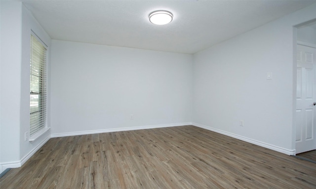 spare room with hardwood / wood-style floors