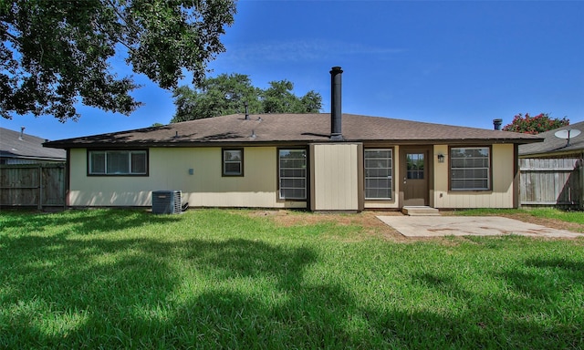 back of property with a patio, a lawn, and central air condition unit