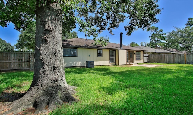 rear view of house with a patio area and a lawn