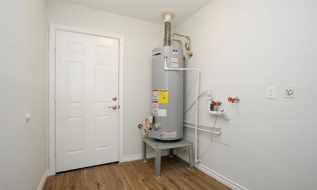 utility room featuring water heater