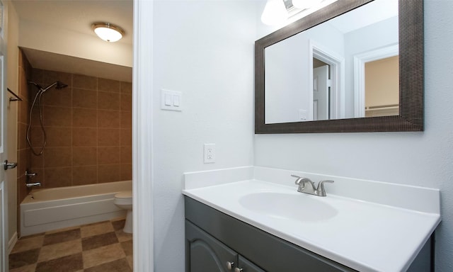 full bathroom with vanity, tiled shower / bath combo, and toilet