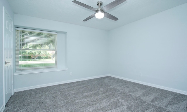 carpeted spare room with ceiling fan