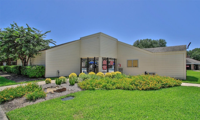 view of side of home with a lawn