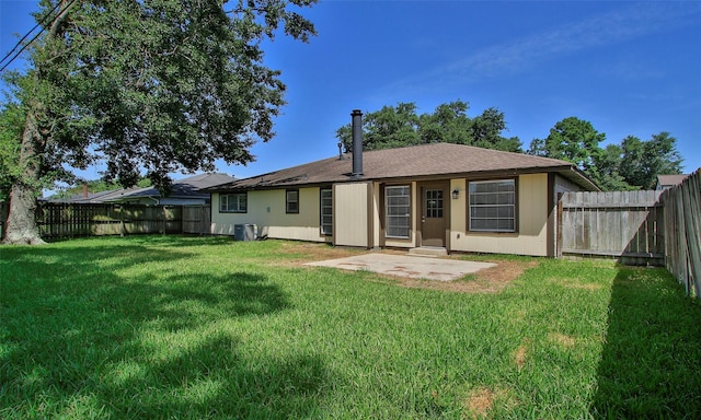 rear view of property with a patio, a yard, and central AC unit