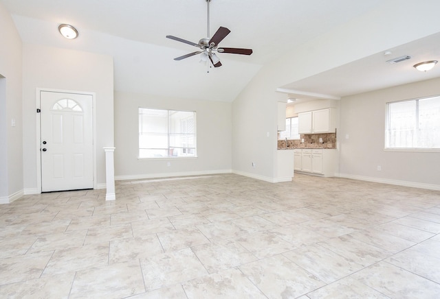 unfurnished living room with vaulted ceiling and ceiling fan