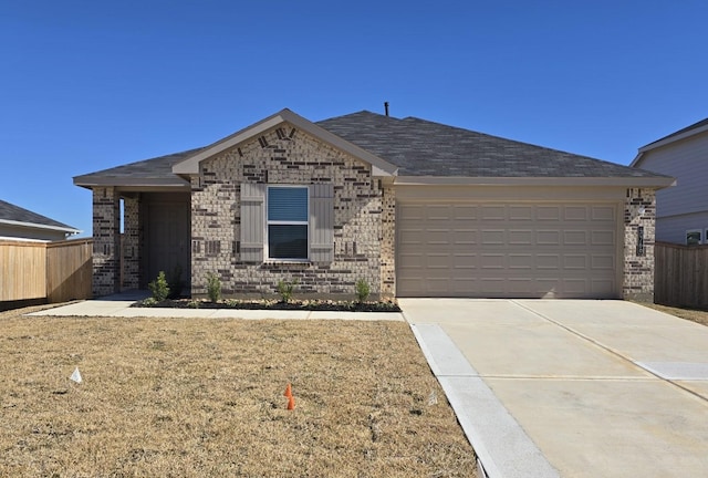 ranch-style home featuring a garage and a front lawn