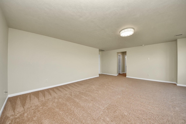 carpeted spare room with a textured ceiling