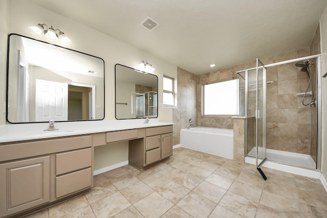 bathroom featuring vanity and shower with separate bathtub