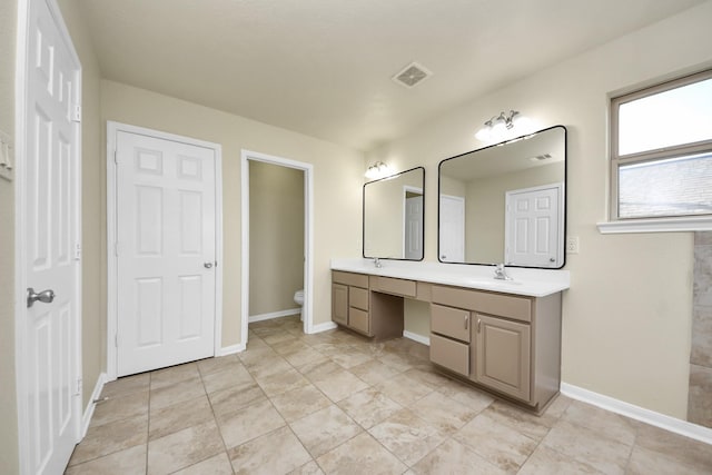 bathroom with vanity and toilet