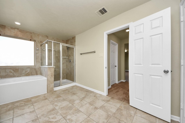 bathroom featuring tile patterned floors and independent shower and bath