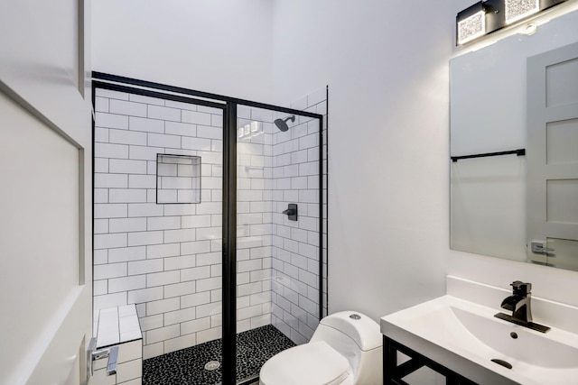 bathroom with vanity, toilet, and a shower with shower door