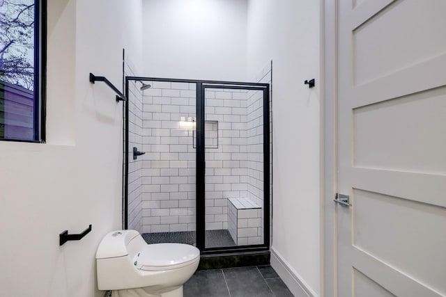 bathroom with toilet, a shower with shower door, and tile patterned flooring