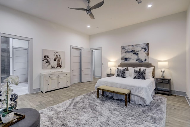 bedroom with ceiling fan and light wood-type flooring