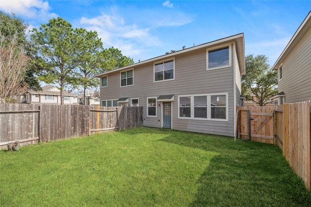 back of house featuring a yard