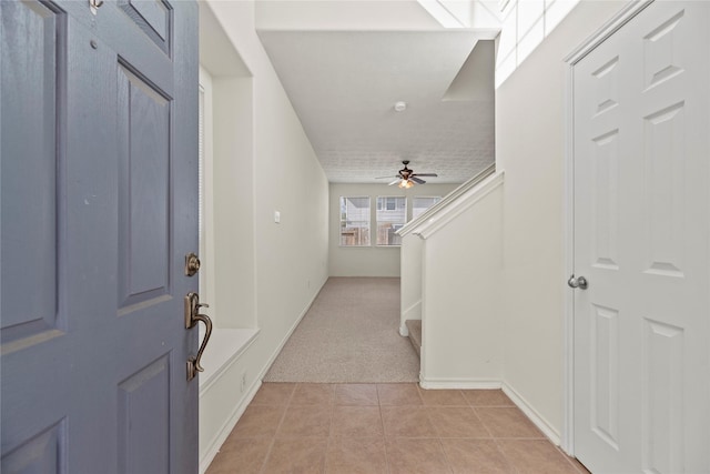 entrance foyer featuring light tile patterned flooring and ceiling fan