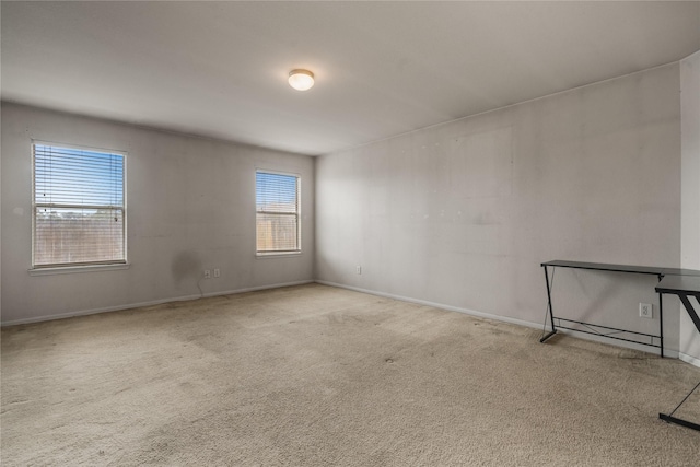 unfurnished room featuring light carpet