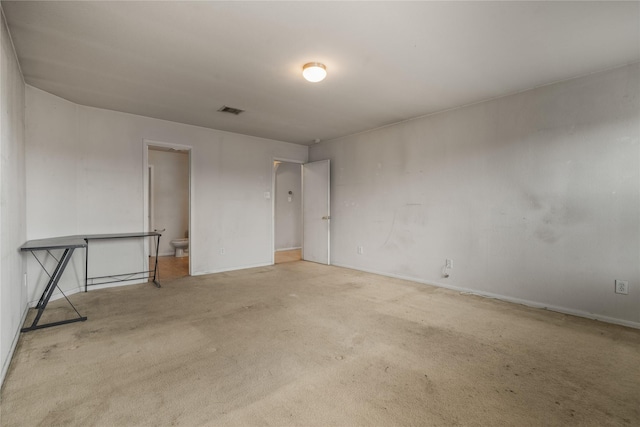 spare room featuring light colored carpet