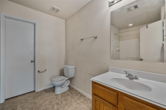 bathroom with tile patterned flooring, vanity, and toilet