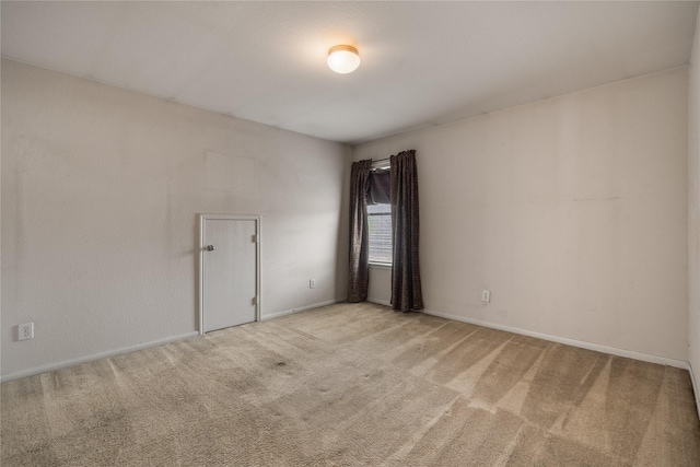 unfurnished room featuring light colored carpet