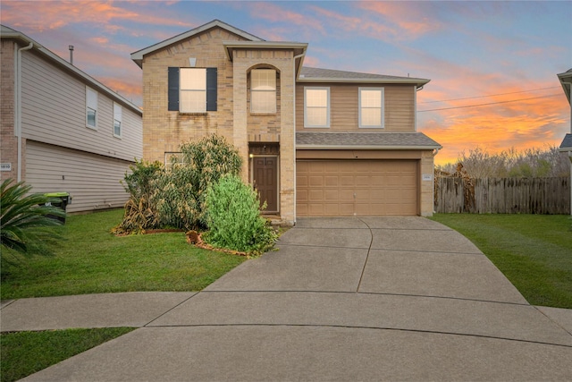 view of front of home featuring a garage and a yard