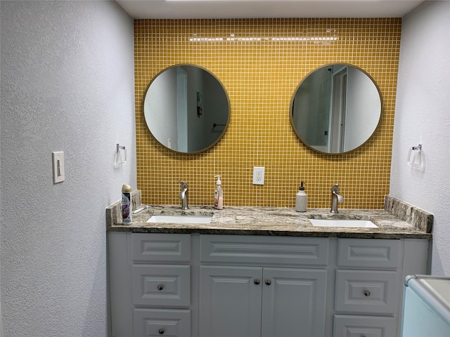 bathroom featuring vanity and decorative backsplash