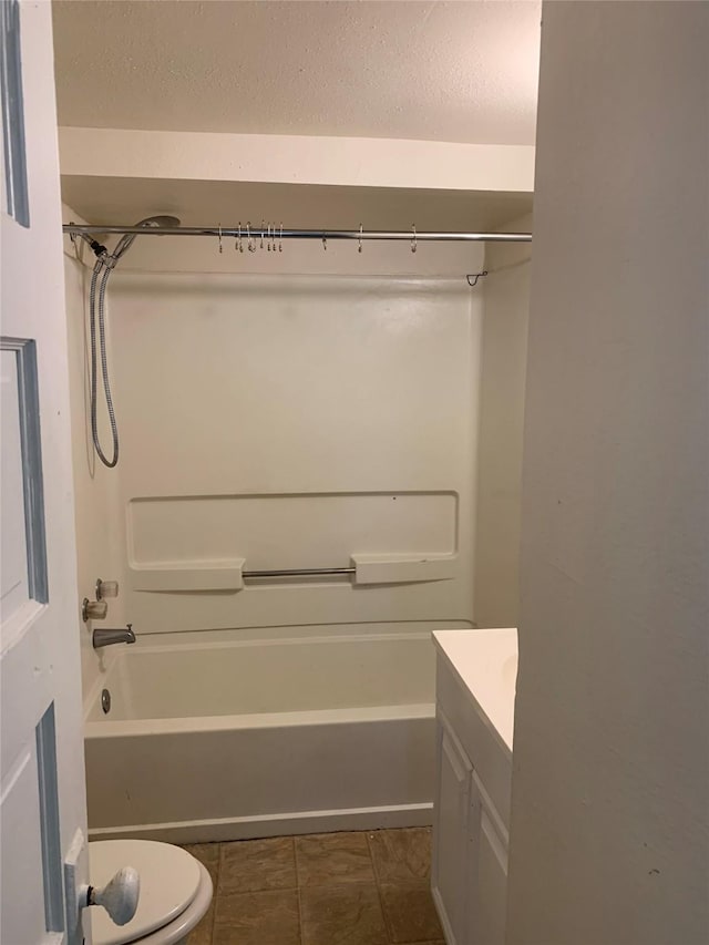 full bathroom featuring vanity, a textured ceiling, shower / washtub combination, and toilet