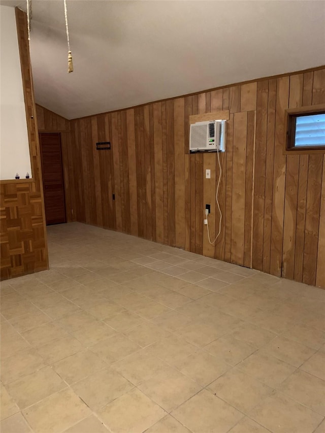 basement with an AC wall unit and wood walls