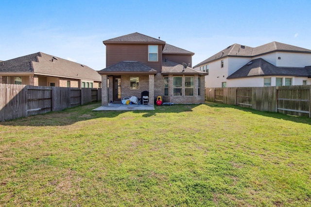 rear view of property featuring a lawn and a patio