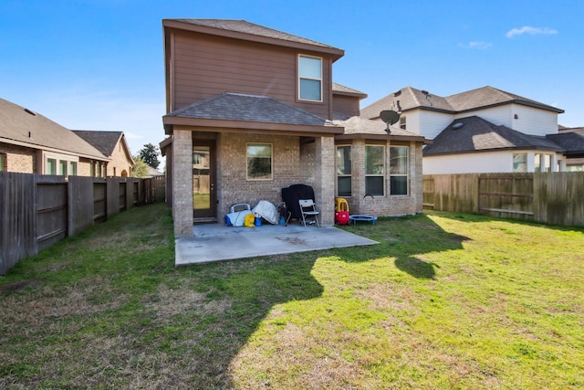 rear view of house featuring a patio area and a lawn