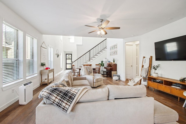 living room featuring ceiling fan and dark hardwood / wood-style floors