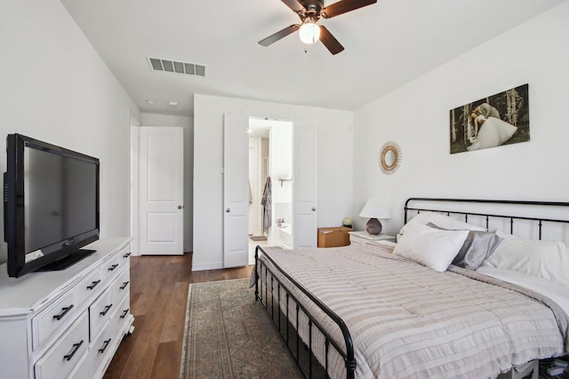 bedroom with dark wood-type flooring, connected bathroom, and ceiling fan