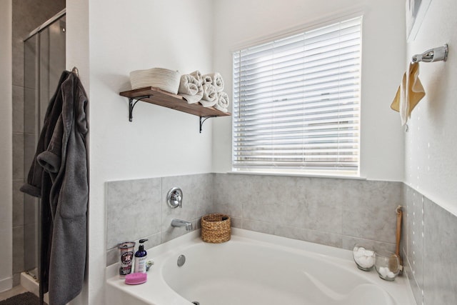 bathroom featuring independent shower and bath