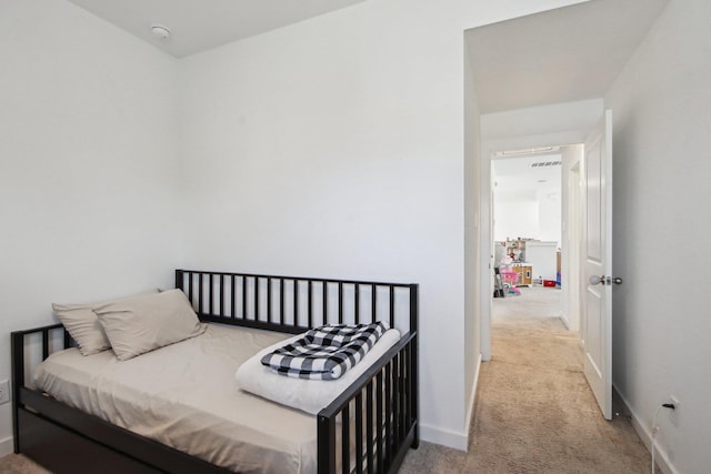 bedroom featuring light carpet