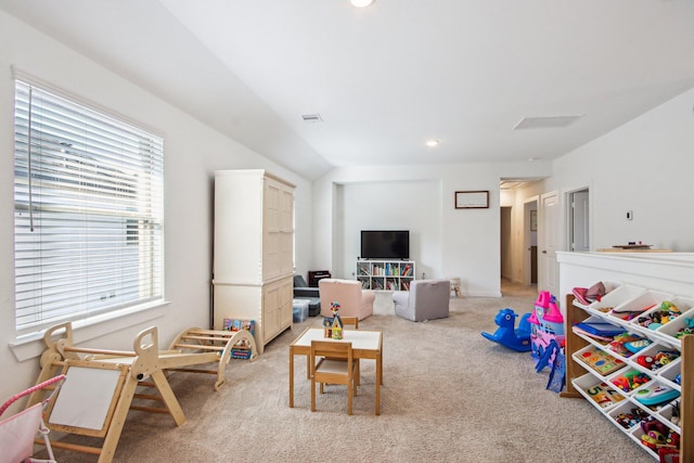 rec room with lofted ceiling and light colored carpet