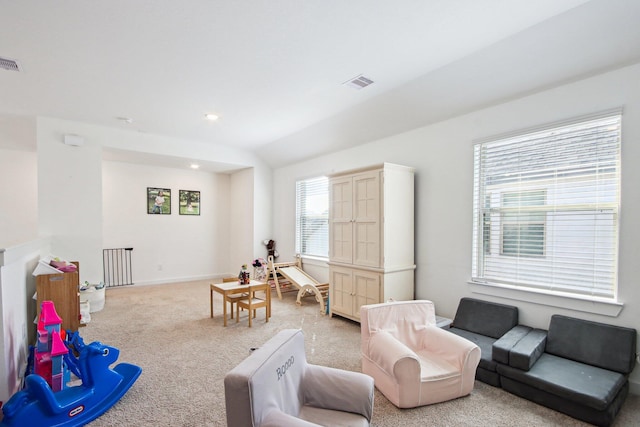 living room with vaulted ceiling and light carpet