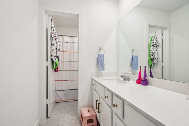 bathroom with tile patterned flooring and vanity