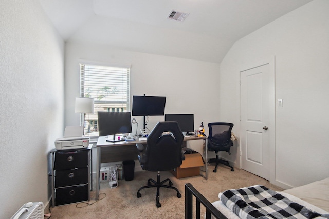 carpeted office with lofted ceiling