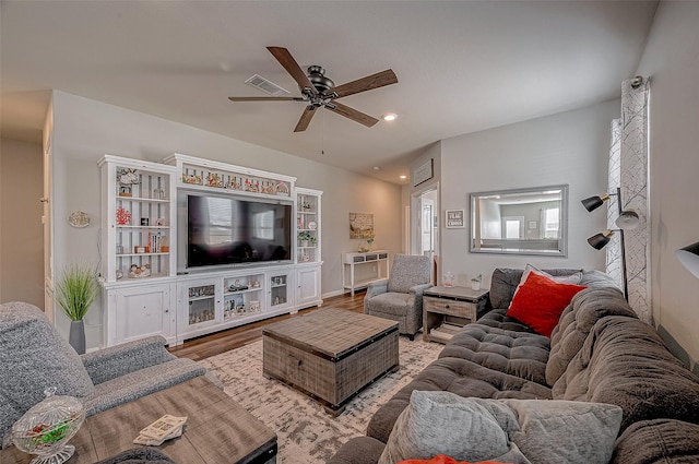 living room featuring wood-type flooring and ceiling fan