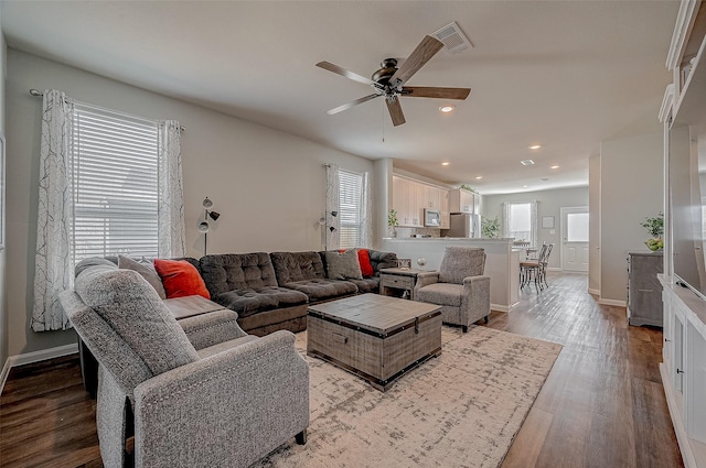 living room with ceiling fan and light wood-type flooring