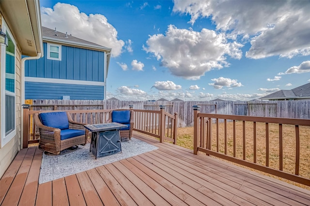 wooden deck featuring an outdoor fire pit