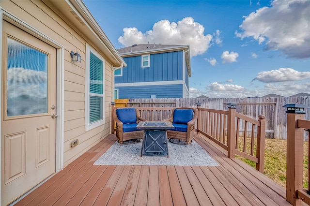 wooden terrace featuring an outdoor fire pit