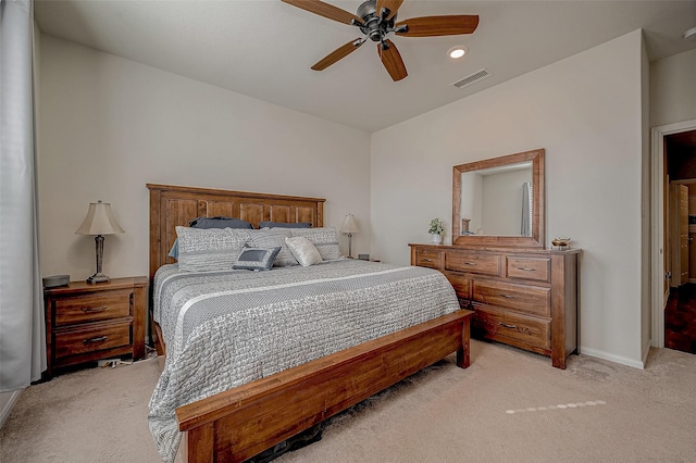 bedroom with ceiling fan and light colored carpet