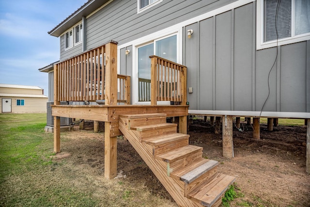 wooden deck featuring central AC and a lawn