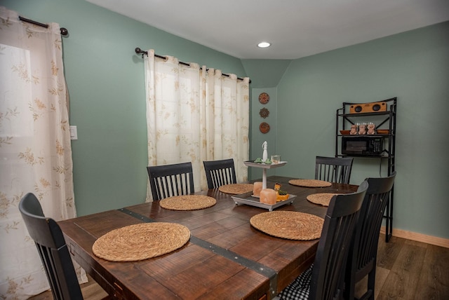 dining area featuring dark wood-type flooring